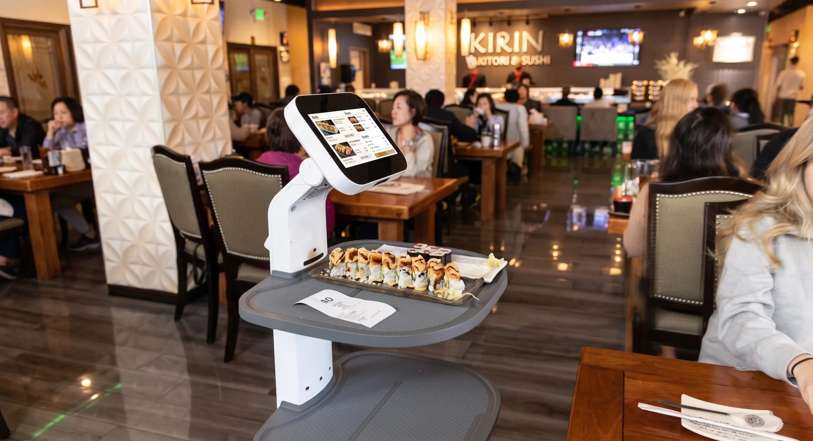 OpenDroids delivery robot running plates in a late-night diner interior