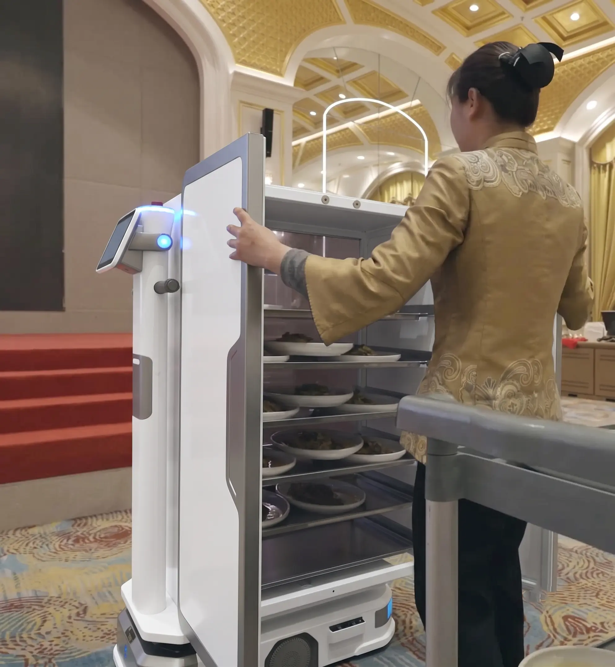 OpenDroids delivery robot carrying a to-go order through a restaurant parking lot
